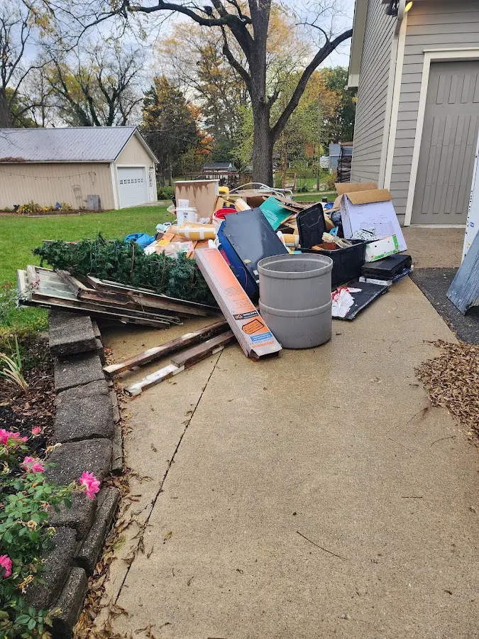 Dumpster being loaded with debris for Residential Dumpster Rental in Manvel